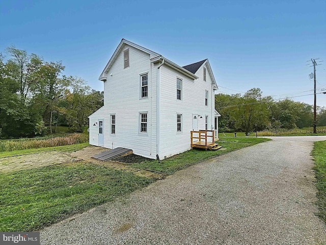 view of property exterior with a yard