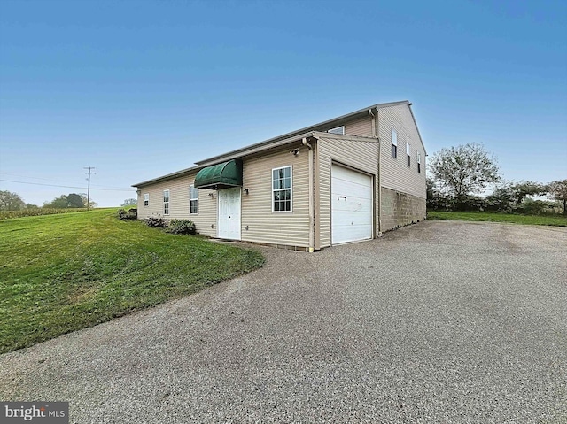 view of front of house featuring a garage and a front lawn