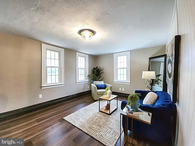 living room with a textured ceiling, dark hardwood / wood-style flooring, and a baseboard radiator