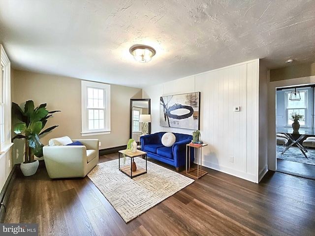 living room featuring dark hardwood / wood-style floors and a textured ceiling