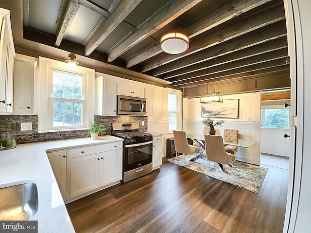 kitchen featuring white cabinetry, stainless steel appliances, dark hardwood / wood-style floors, decorative light fixtures, and decorative backsplash