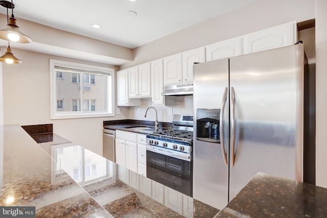 kitchen featuring white cabinetry, sink, dark stone counters, and appliances with stainless steel finishes