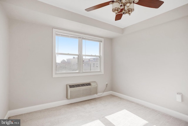 unfurnished room with ceiling fan, a wall mounted air conditioner, and carpet