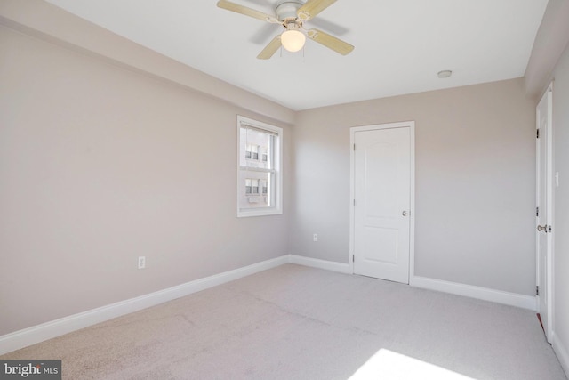 unfurnished bedroom featuring ceiling fan and light colored carpet