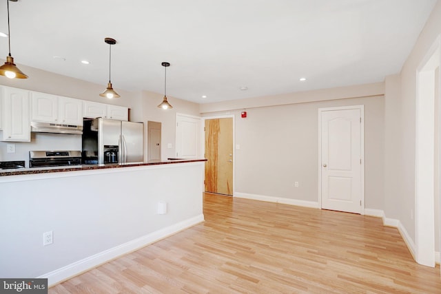 kitchen with white cabinetry, hanging light fixtures, light hardwood / wood-style flooring, and appliances with stainless steel finishes