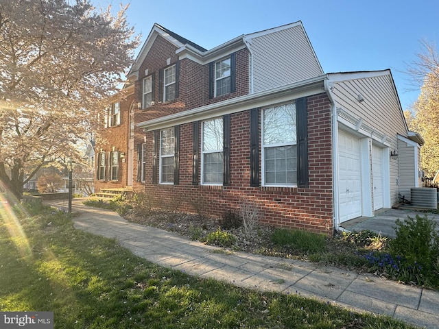 view of home's exterior with a garage and central air condition unit