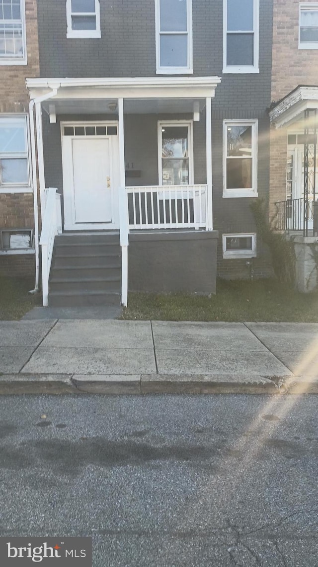 property entrance featuring brick siding