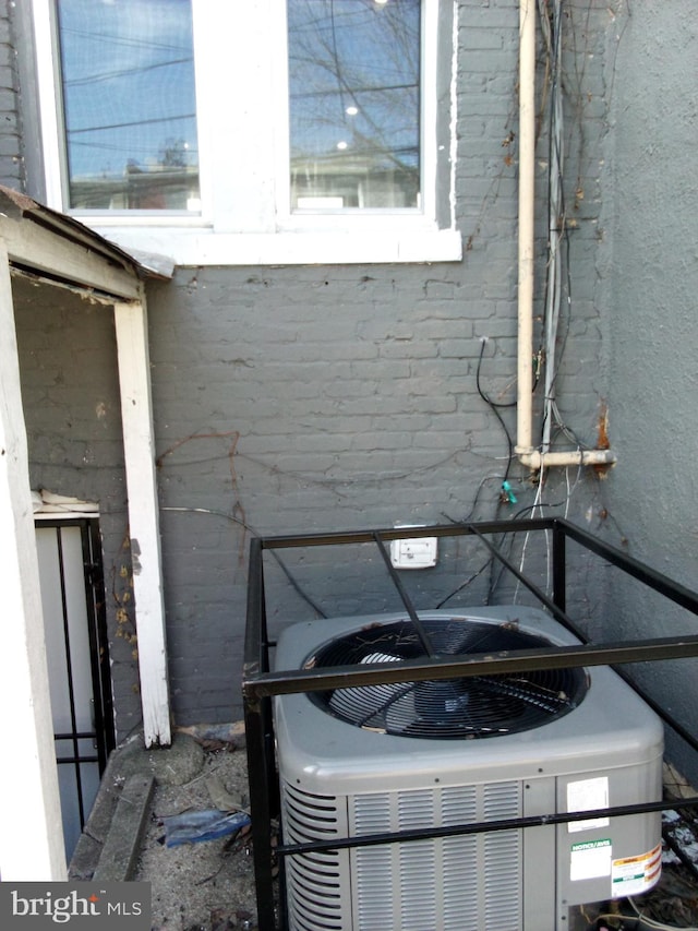 details with central AC unit and brick siding