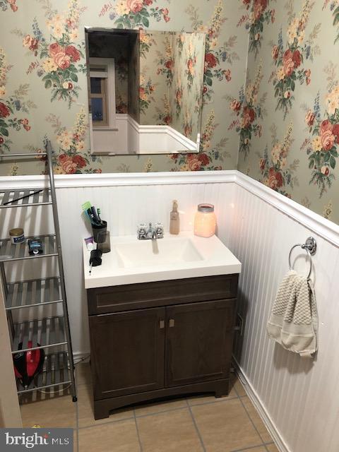 bathroom featuring tile patterned flooring and vanity