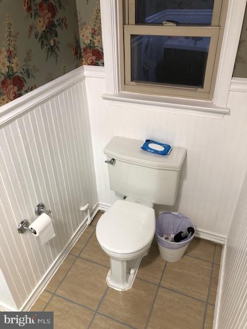 bathroom featuring tile patterned flooring and toilet