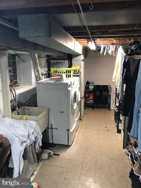 clothes washing area with sink and washer and dryer