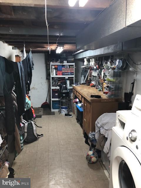 basement featuring washer / dryer and a workshop area