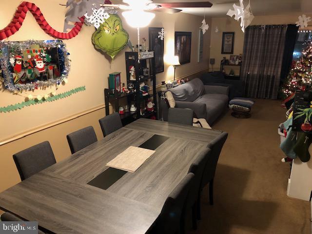 dining room featuring carpet flooring and ceiling fan