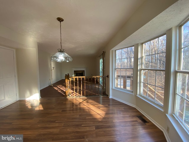 dining space with plenty of natural light and dark hardwood / wood-style flooring