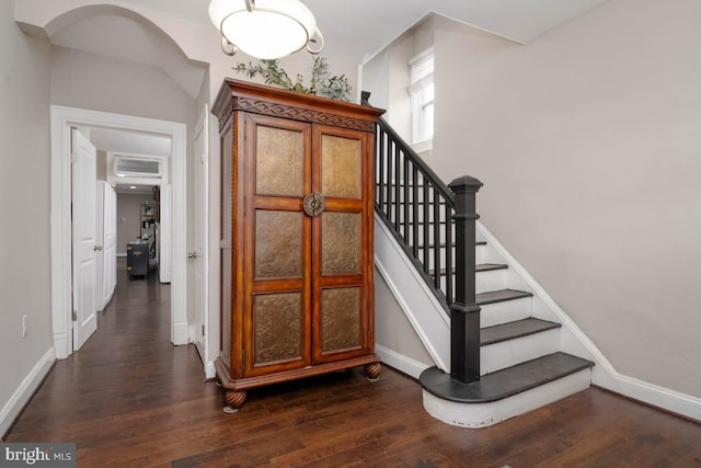 stairs featuring hardwood / wood-style floors