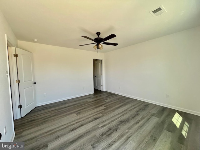 unfurnished bedroom featuring baseboards, visible vents, ceiling fan, and dark wood-style flooring