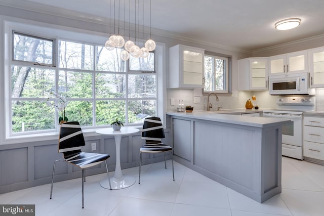 kitchen with white cabinetry, crown molding, decorative light fixtures, white appliances, and backsplash