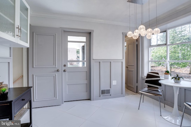 interior space with crown molding, light tile patterned floors, and a chandelier