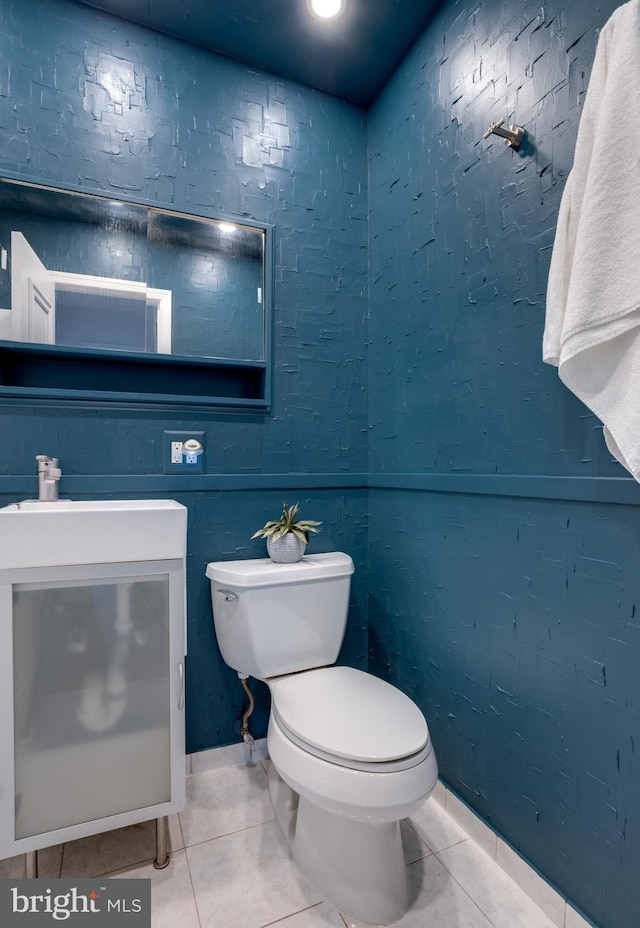 bathroom featuring tile patterned flooring, vanity, and toilet