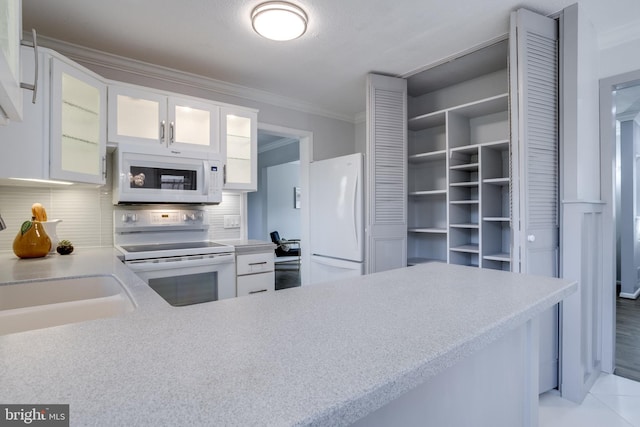 kitchen with sink, white cabinetry, crown molding, white appliances, and decorative backsplash