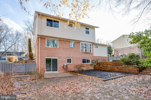 rear view of property featuring central AC unit and a patio