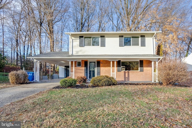 view of front of house with a carport and a front yard