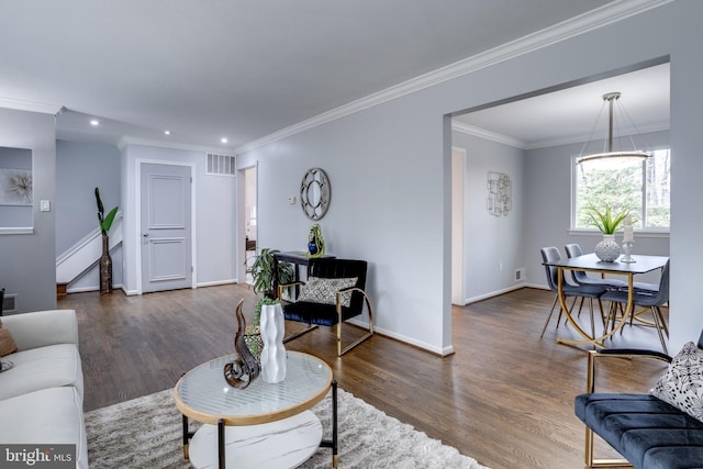 living room featuring ornamental molding and dark hardwood / wood-style flooring