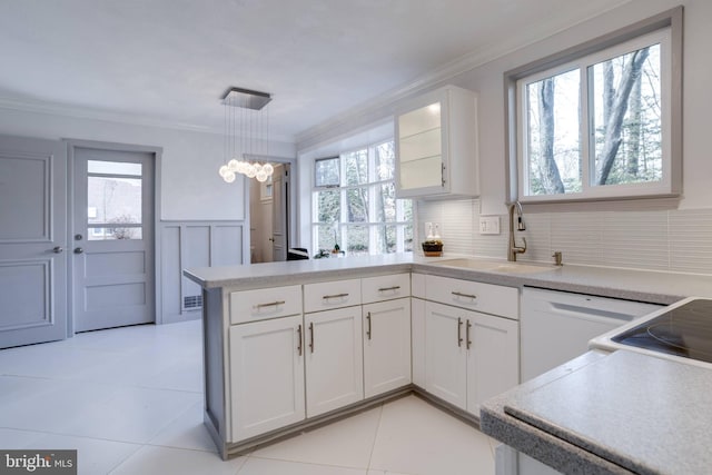 kitchen featuring white cabinetry, sink, pendant lighting, and crown molding