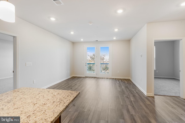 unfurnished living room with dark hardwood / wood-style flooring