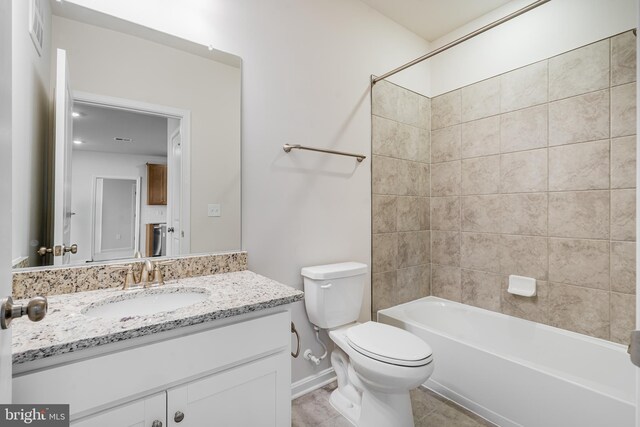 full bathroom with tile patterned flooring, vanity, toilet, and tiled shower / bath