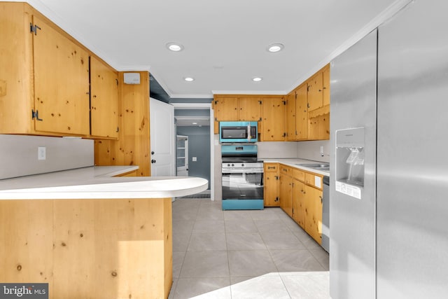 kitchen featuring kitchen peninsula, appliances with stainless steel finishes, crown molding, and sink