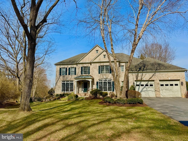 view of front of house featuring a front yard, an attached garage, and driveway