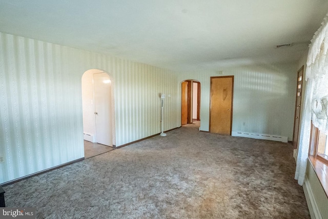 carpeted empty room featuring a baseboard radiator