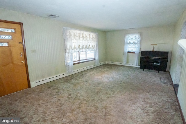 unfurnished living room featuring carpet floors and a baseboard radiator