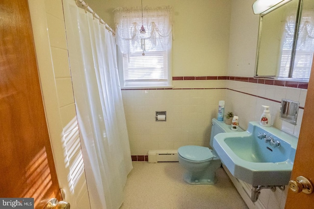 bathroom featuring sink, a baseboard radiator, walk in shower, toilet, and tile walls