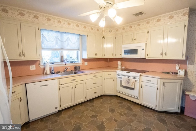 kitchen with white appliances, white cabinetry, ceiling fan, and sink