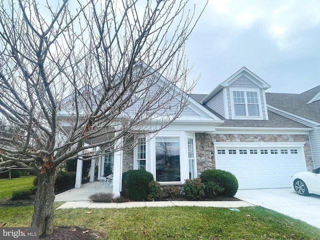 view of front of house with a garage and a front yard