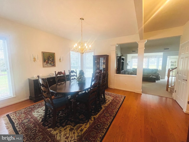 dining space with a chandelier, hardwood / wood-style flooring, and a wealth of natural light