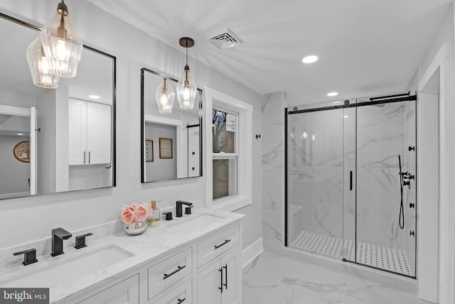 bathroom with vanity and a shower with shower door