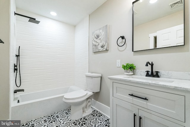 full bathroom with tile patterned floors, tiled shower / bath, vanity, and toilet