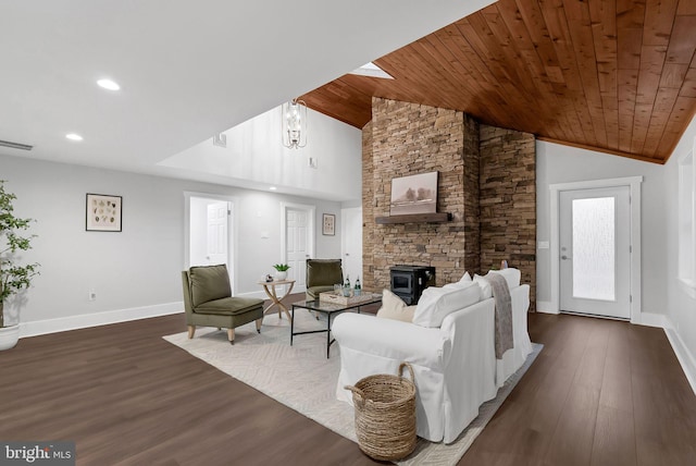 living room featuring dark hardwood / wood-style flooring, wood ceiling, vaulted ceiling, a chandelier, and a wood stove