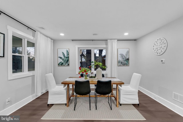 dining area featuring dark wood-type flooring