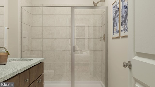 bathroom with a shower with door and vanity