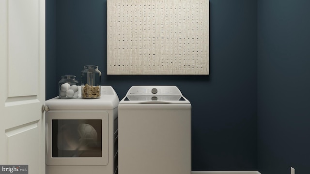 laundry area with washing machine and clothes dryer