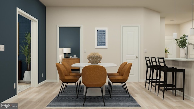 dining room featuring light hardwood / wood-style flooring and sink