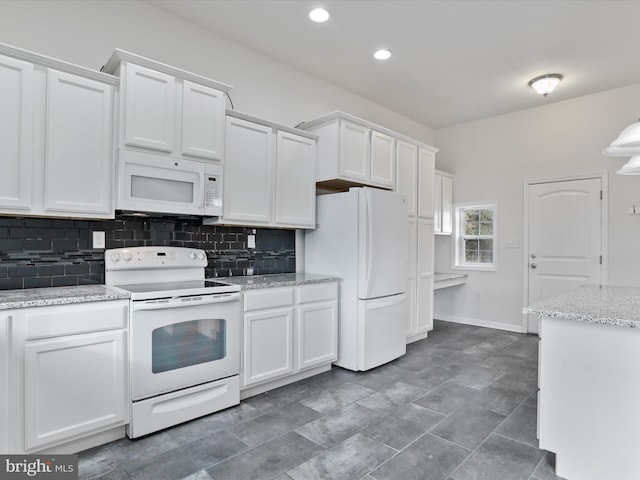 kitchen with white cabinets, white appliances, light stone countertops, and backsplash