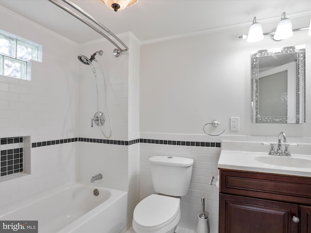 full bathroom with vanity, crown molding, tiled shower / bath, toilet, and tile walls