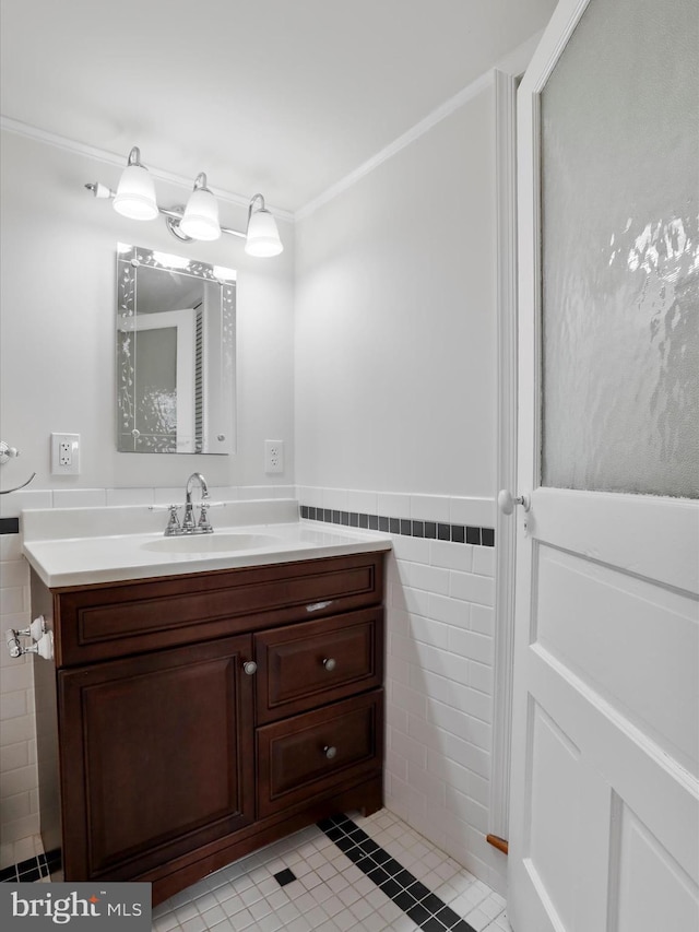 bathroom featuring tile patterned flooring, vanity, tile walls, and ornamental molding