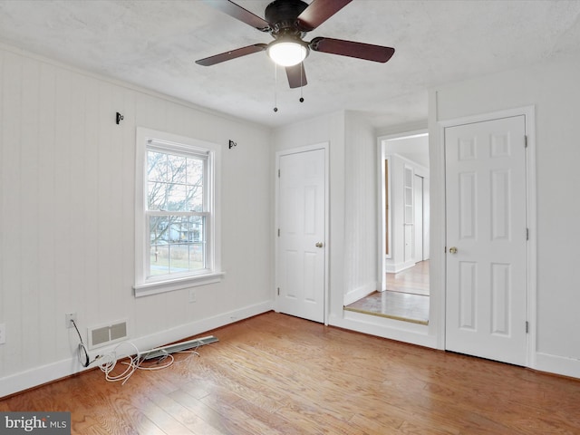 unfurnished bedroom featuring ceiling fan and light wood-type flooring