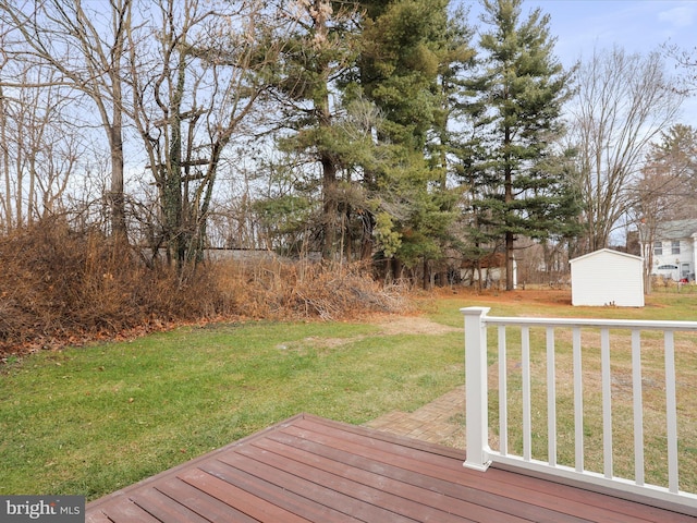 wooden terrace with a lawn